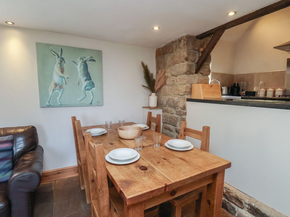 A dining room with a wooden table and chairs at Horseshoe Cottage Ingleby Greenhow near Great Ayton