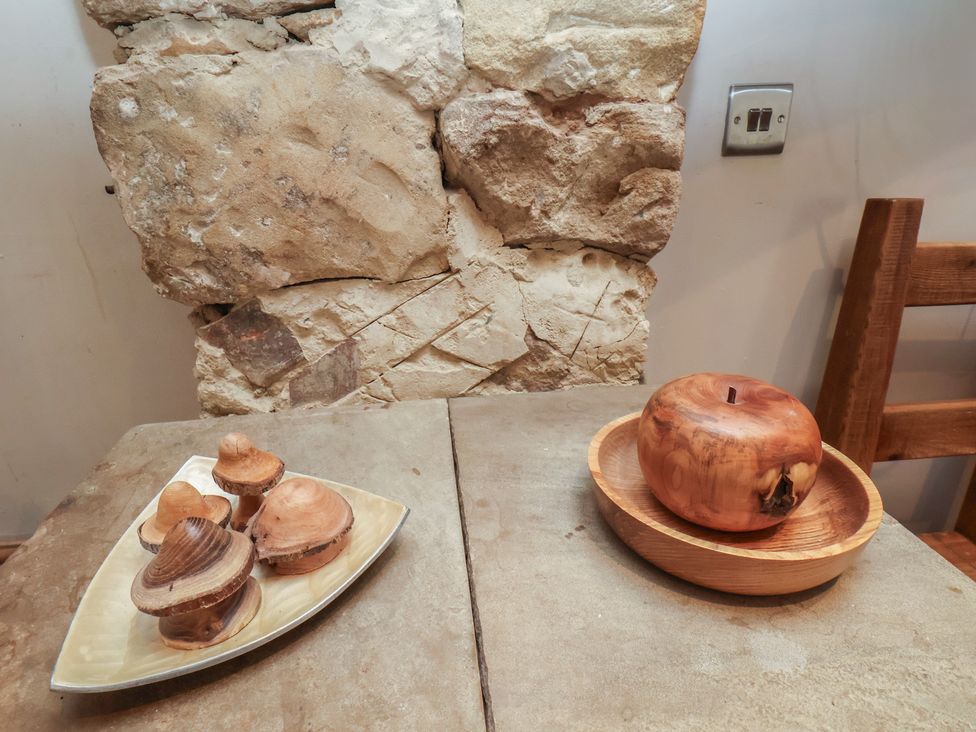 A wooden table with decorative wooden items at Horseshoe Cottage Ingleby Greenhow near Great Ayton