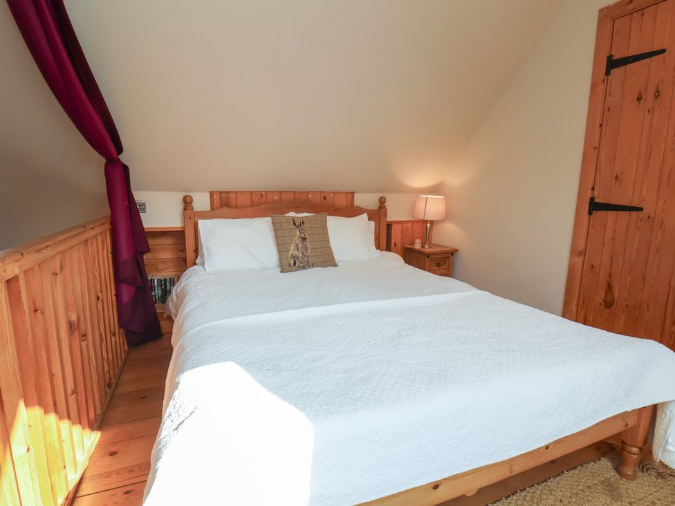 A bedroom with a bed and bedside table at Horseshoe Cottage Ingleby Greenhow near Great Ayton