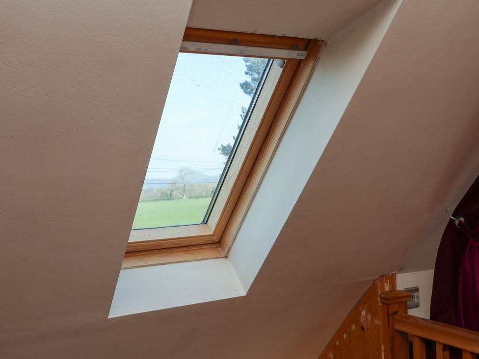 A skylight in an attic with a view of the outdoors at Horseshoe Cottage in Ingleby Greenhow near Great Ayton
