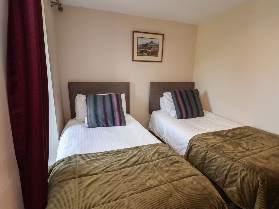 A bedroom with two single beds at Horseshoe Cottage Ingleby Greenhow near Great Ayton