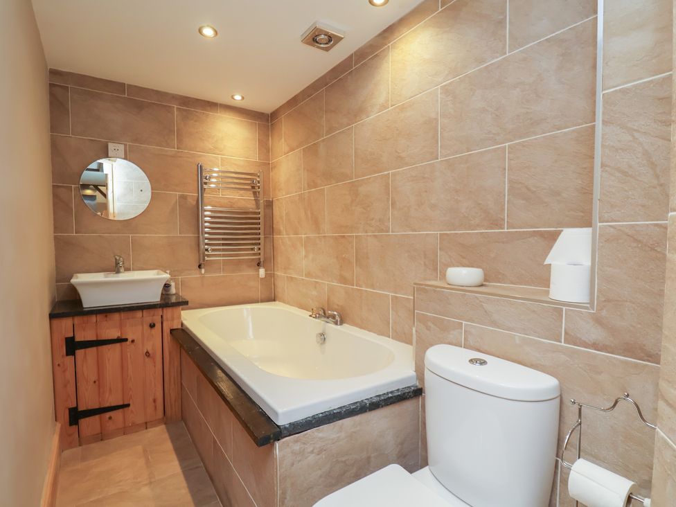 A bathroom with a bathtub and sink at Horseshoe Cottage Ingleby Greenhow near Great Ayton