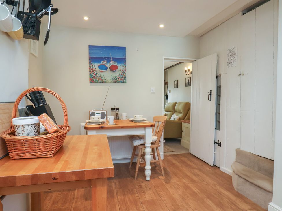 A dining room with a table and chairs at Seashell Cottage