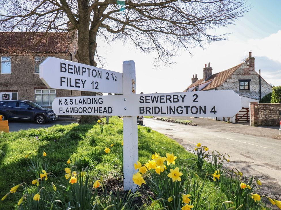 A directional sign showing distances to various locations in a rural area at Seashell Cottage