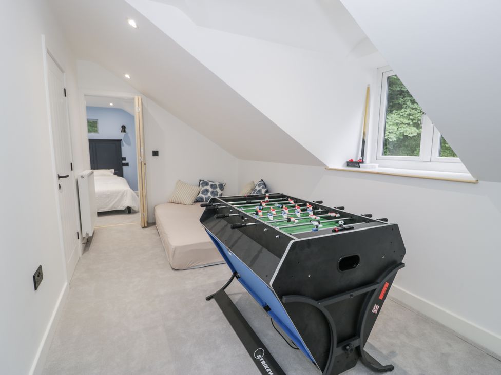 A games room with a foosball table and bed at Frongoch Old Power House in Dolgellau