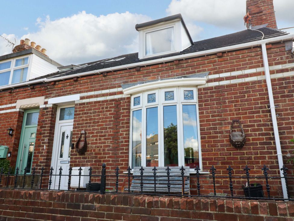 A brick house with a window and door at 8 Percy Terrace, Whitburn