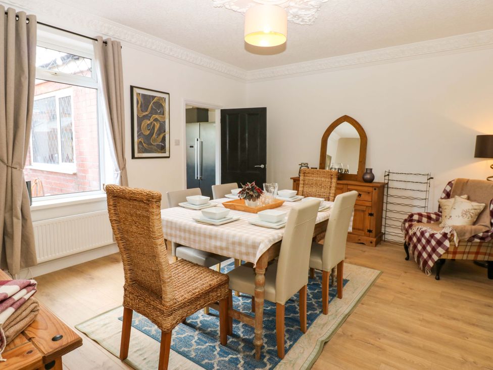 A dining room with a table and chairs at 8 Percy Terrace in Whitburn