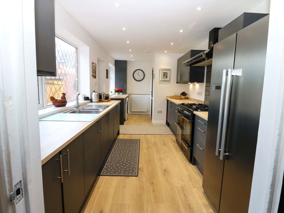 A kitchen with a sink and cooking range at 8 Percy Terrace in Whitburn