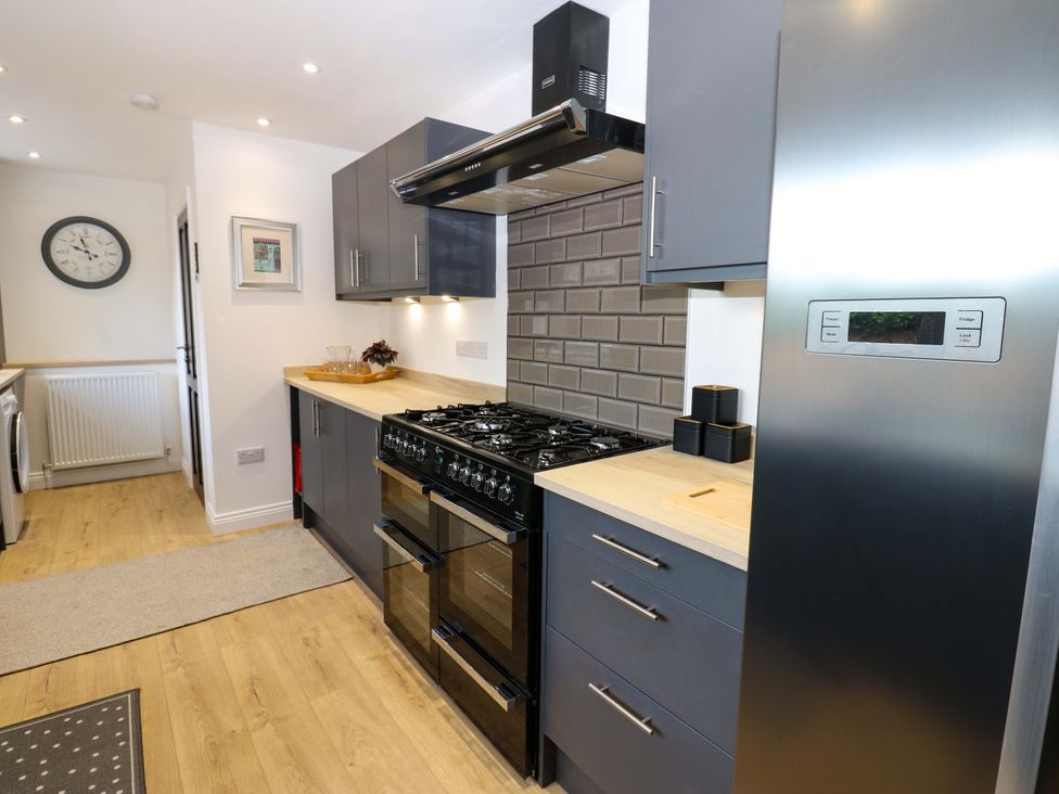 A kitchen with appliances and fixtures at 8 Percy Terrace in Whitburn