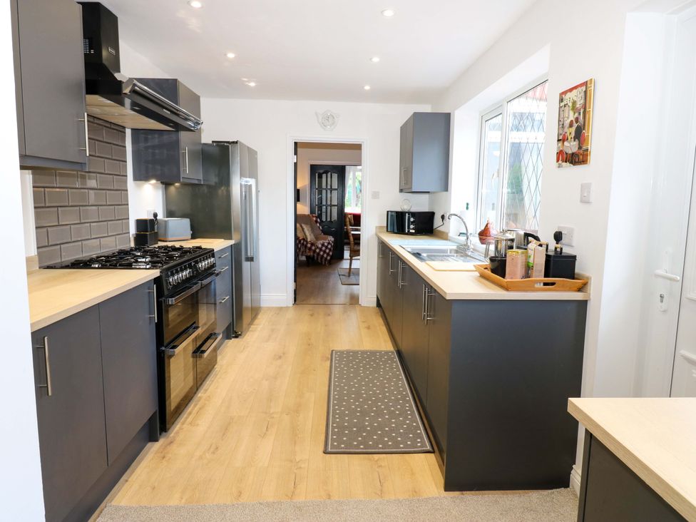 A kitchen with cabinets and appliances at 8 Percy Terrace in Whitburn