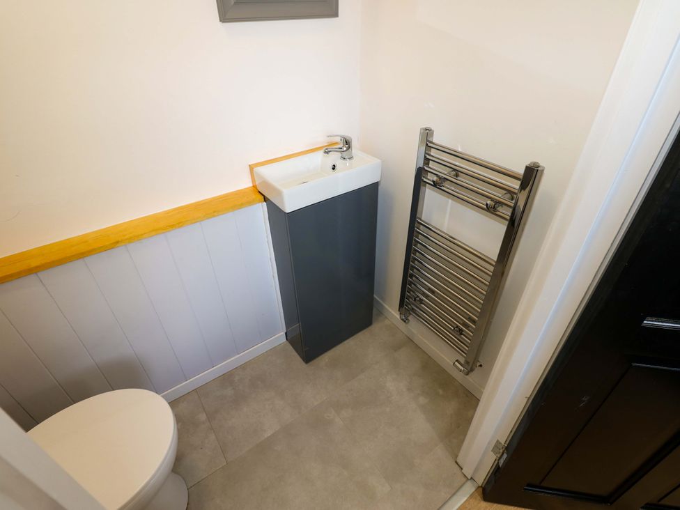 A bathroom with a toilet and sink at 8 Percy Terrace in Whitburn