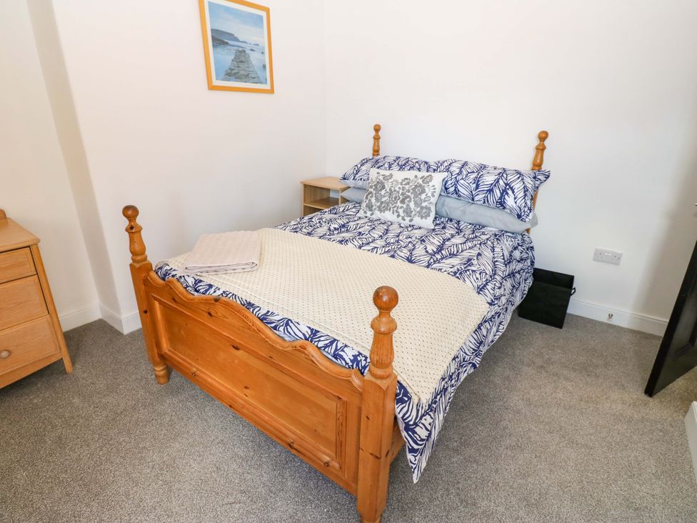 A bedroom with a bed and bedside table at 8 Percy Terrace in Whitburn