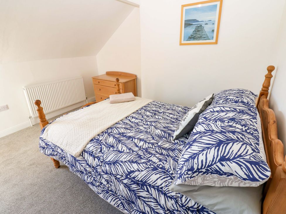 A bedroom with a bed and a chest of drawers at 8 Percy Terrace in Whitburn