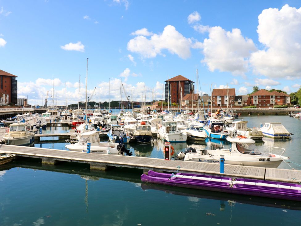 A marina with numerous boats and buildings at 8 Percy Terrace in Whitburn