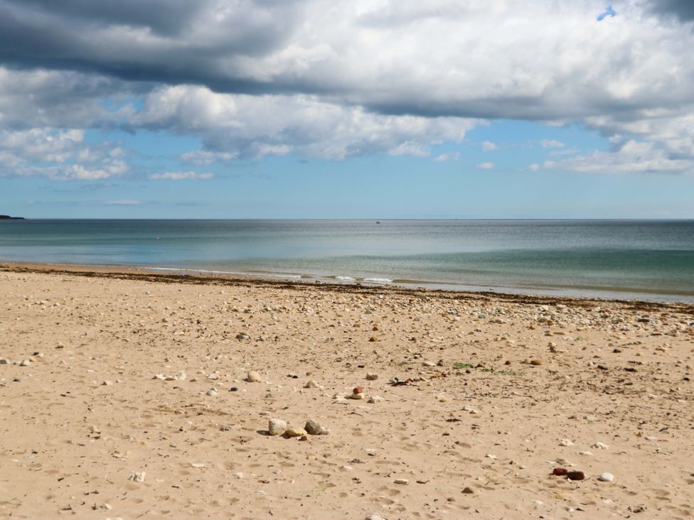 A beach with sand and water at 8 Percy Terrace in Whitburn