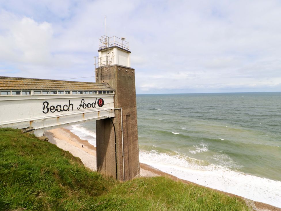 A tower near the sea with a food sign at 8 Percy Terrace in Whitburn