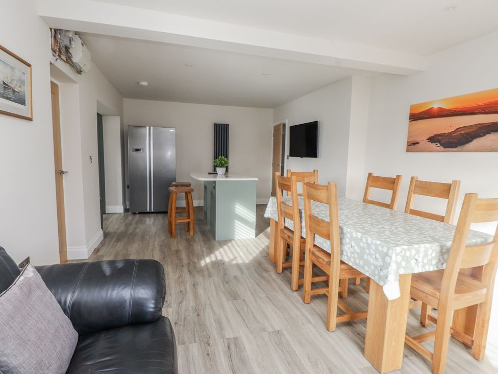 A dining room with a table and chairs at Morannedd in Morfa Nefyn