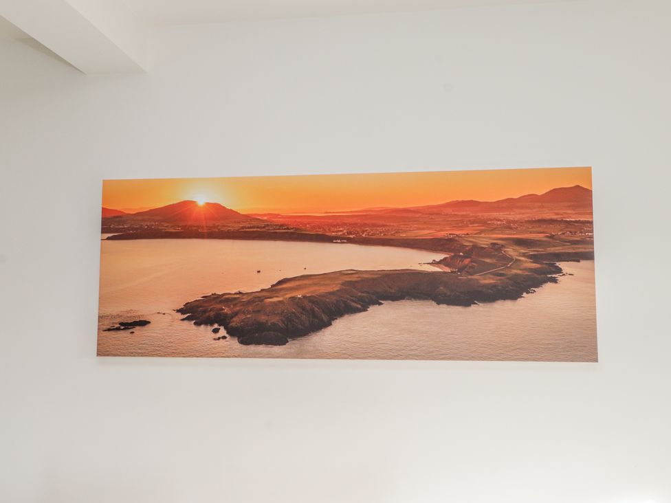 A landscape photograph of a coastline at sunrise at Morannedd in Morfa Nefyn