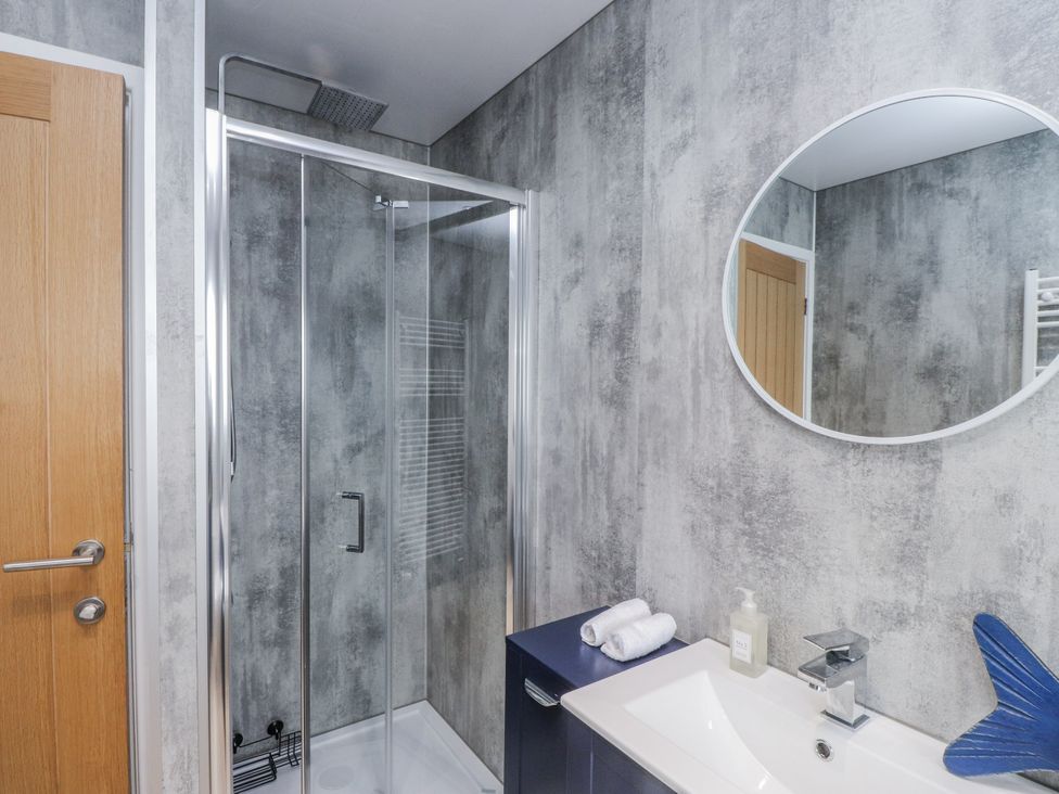 A bathroom with a shower and sink at Morannedd in Morfa Nefyn