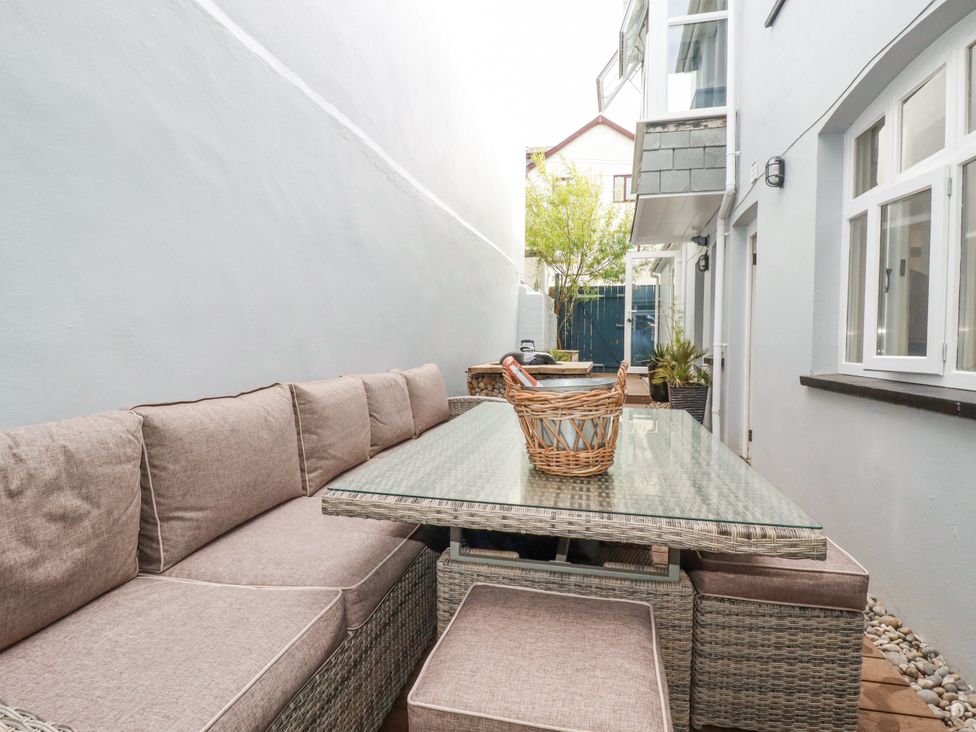An outdoor seating area with a sofa and a table at Beach View House in Newquay