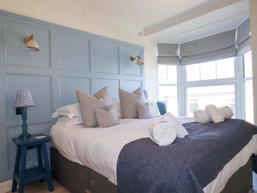 A bedroom with a bed and pillows at Beach View House in Newquay