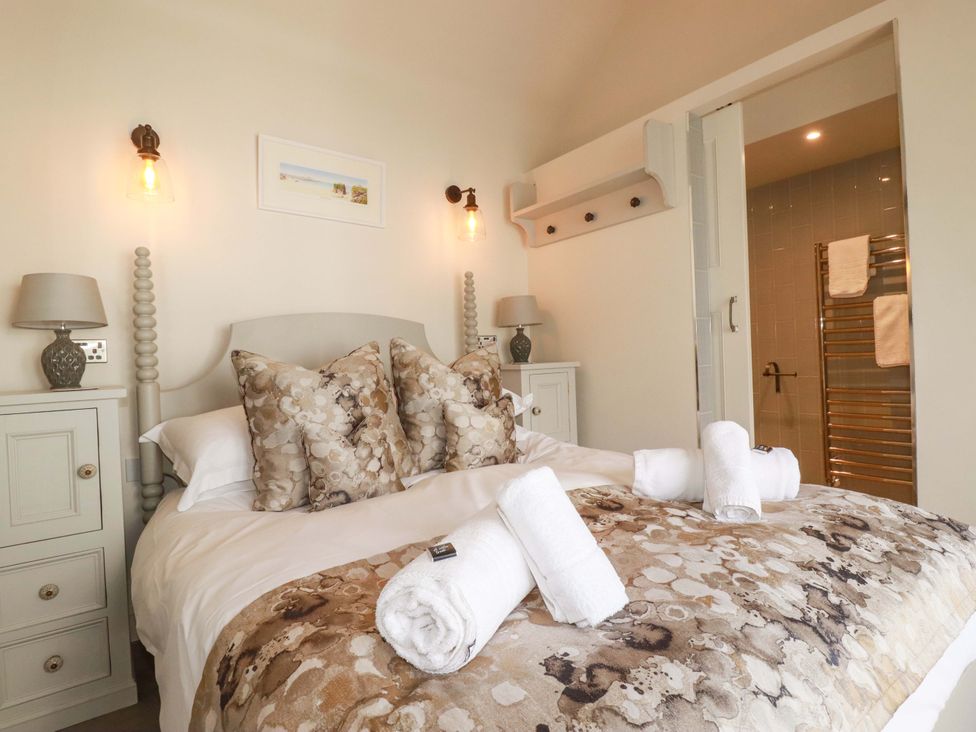 A bedroom with a bed and bedside tables at Beach View House in Newquay