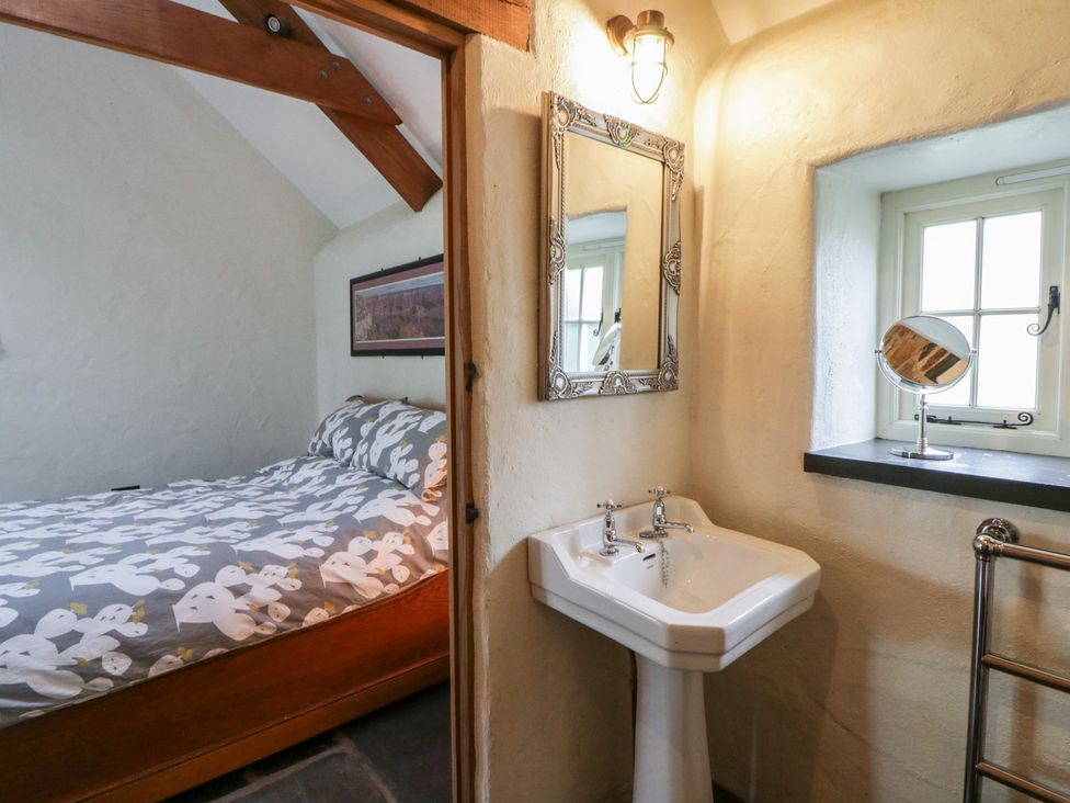 A bedroom with a bed and a sink at St Dogwells Barn near Wolfscastle