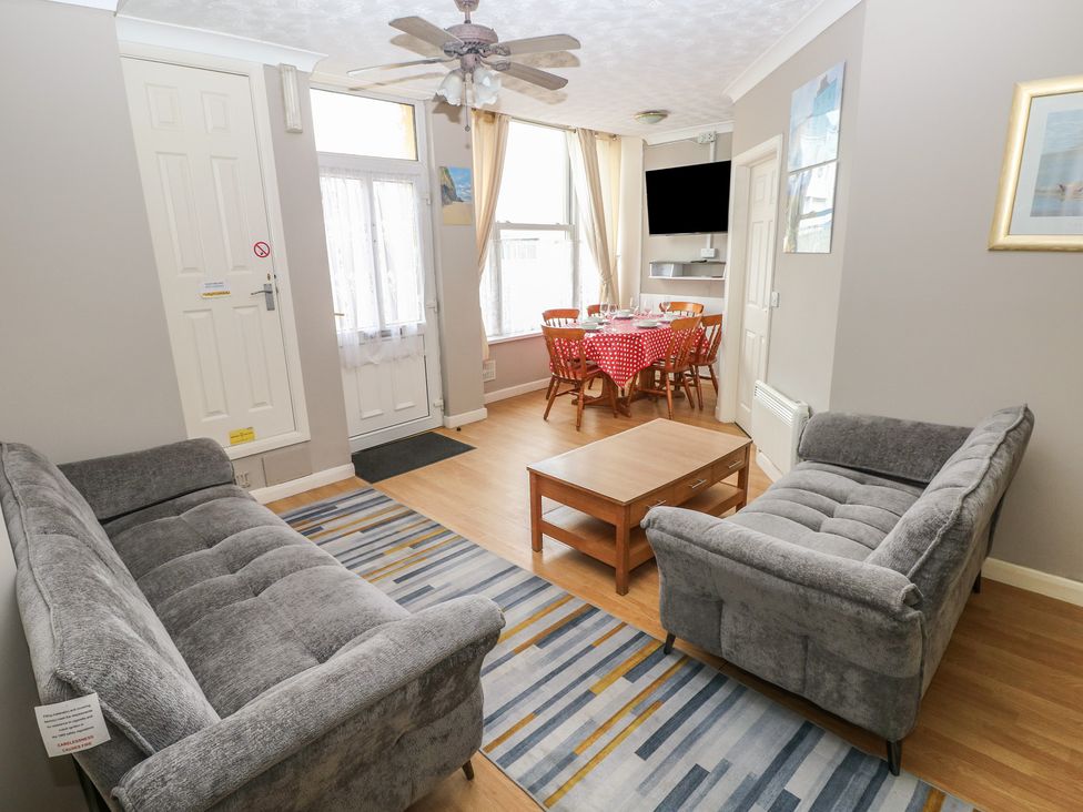 A living room with sofas and a dining area at The Hilton Retreat in Tenby