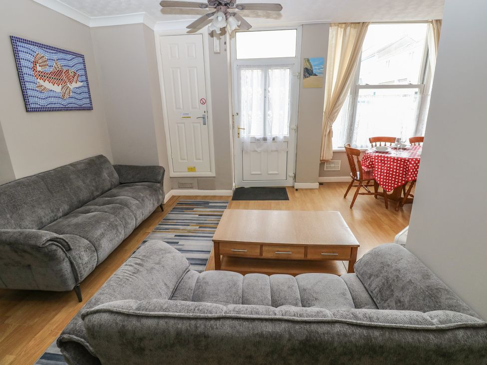 A living room with a sofa and dining area at The Hilton Retreat in Tenby