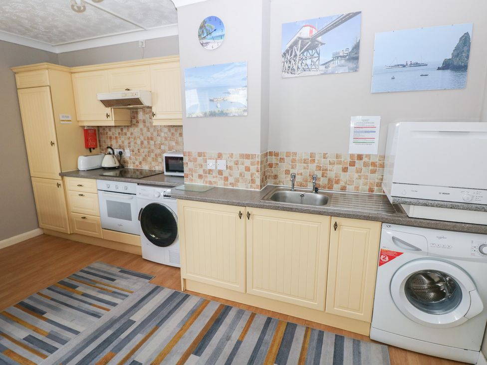 A kitchen with appliances and cabinetry at The Hilton Retreat in Tenby