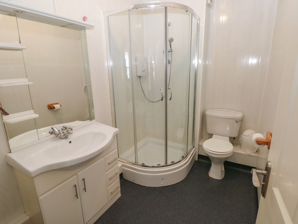 A bathroom with a shower, sink, and toilet at The Hilton Retreat in Tenby