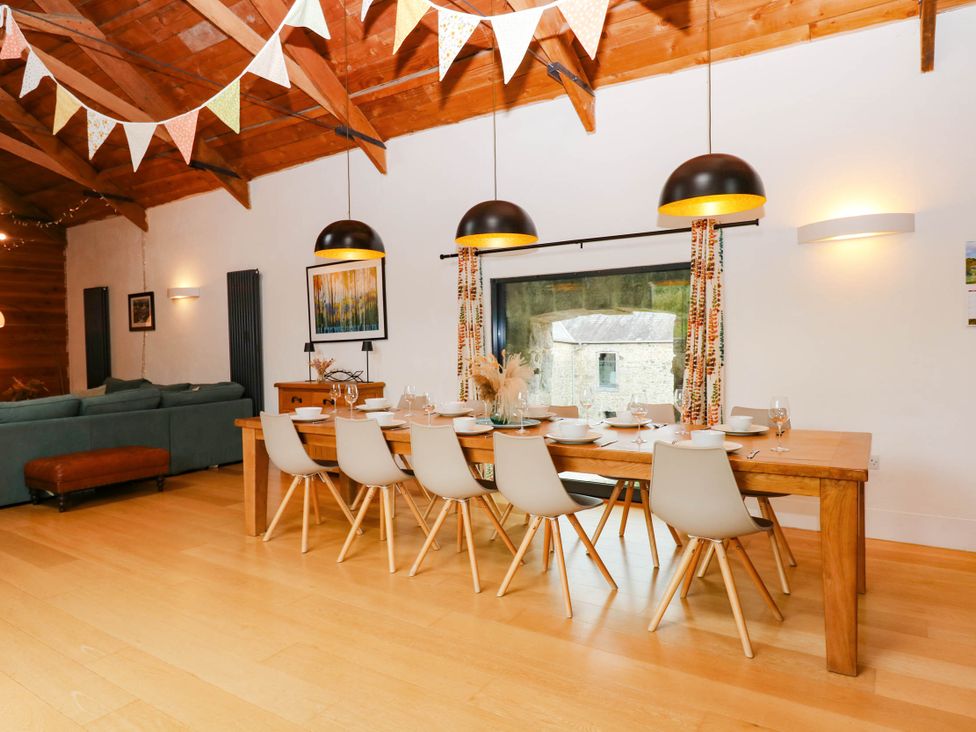 A dining room with a table and chairs at Halshanger Barn in Newton Abbot