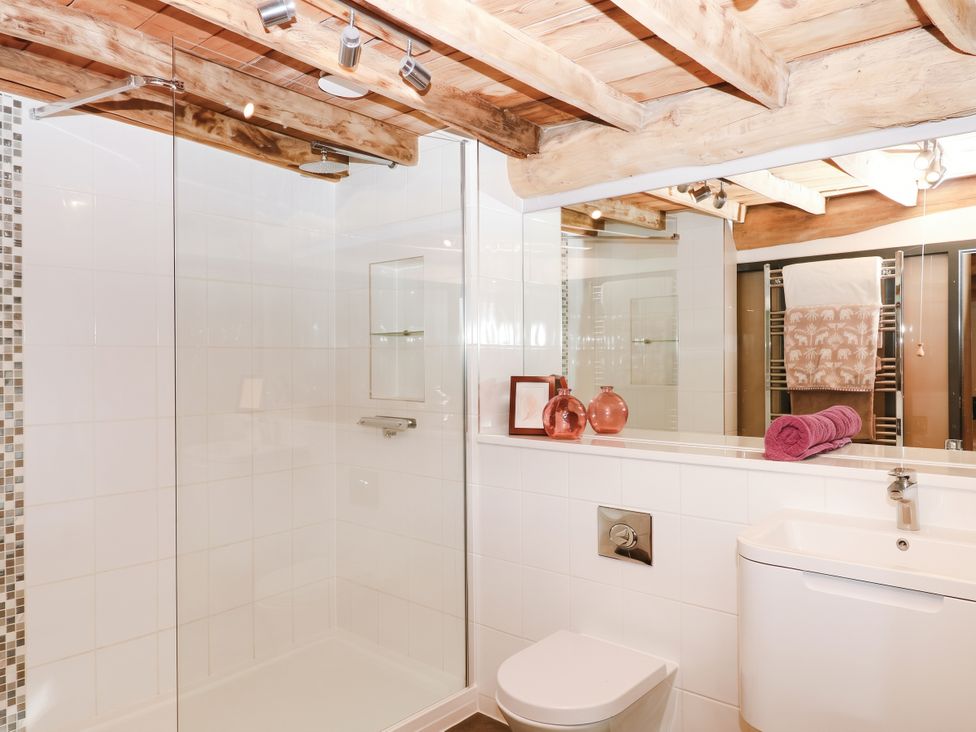 A bathroom with a shower, sink, and toilet at Halshanger Barn in Newton Abbot