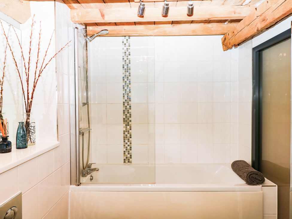 A bathroom with a bathtub and shower at Halshanger Barn in Newton Abbot