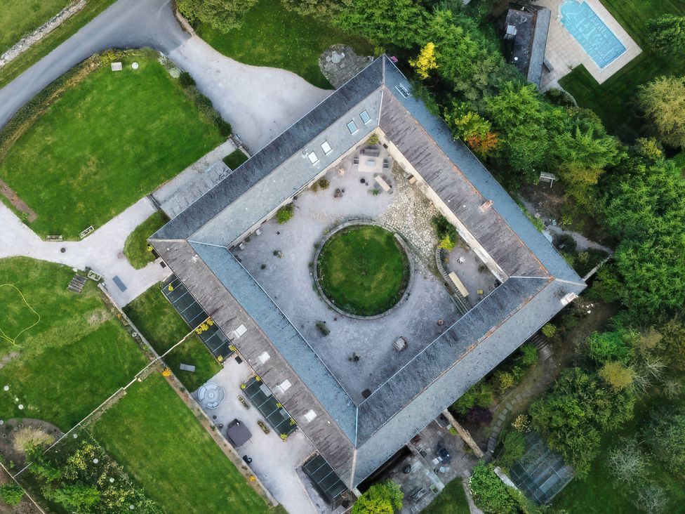 An aerial view of a property with a garden and pool at Halshanger Barn near Ashburton
