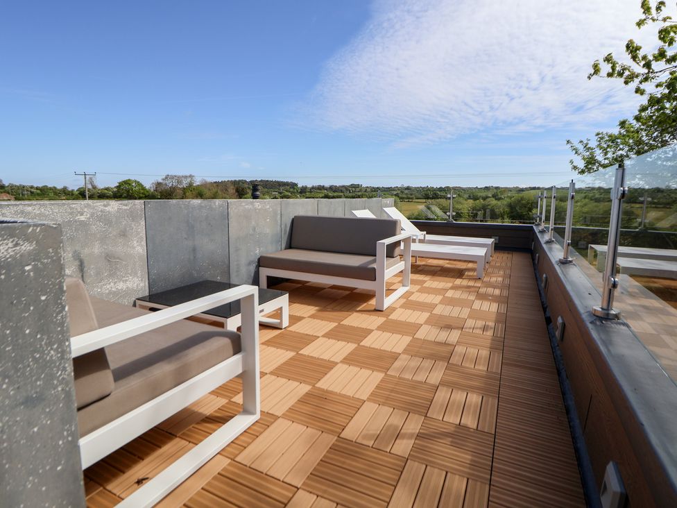 A terrace with outdoor seating and table at The Lodge @ Racecourse House Babell near Holywell