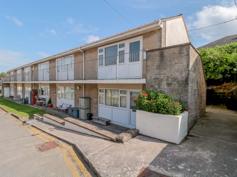A building with balconies and planters at Flat 24 Brean