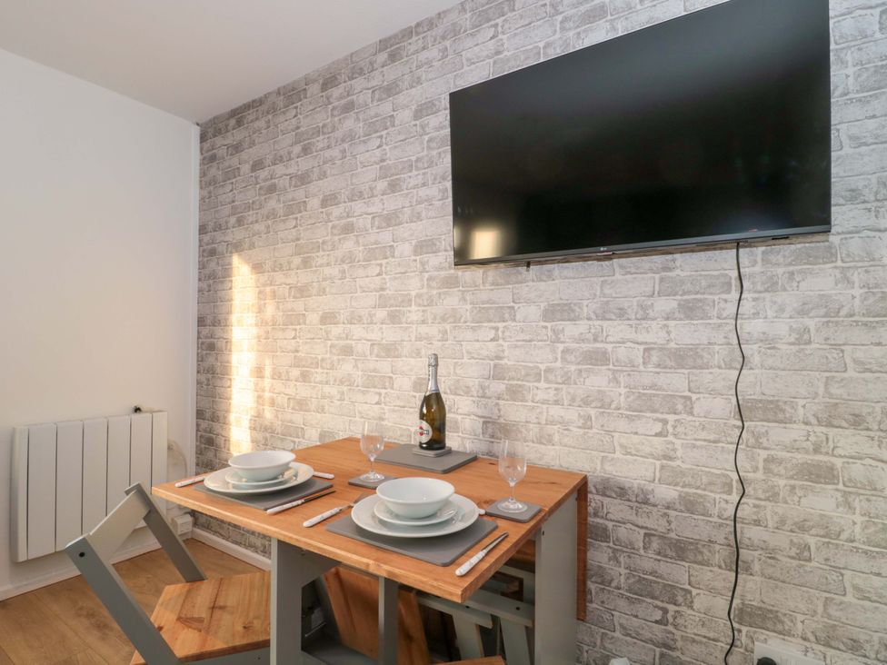 A dining room with a table set for two at Flat 24 in Brean
