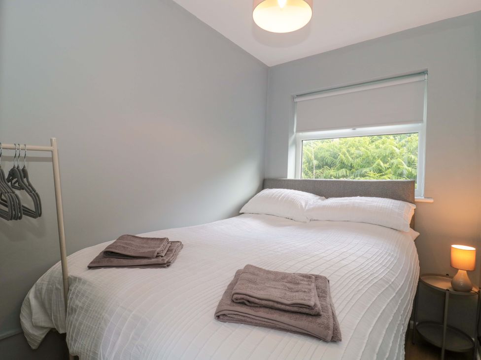 A bedroom with a bed and towels on top at Flat 24 in Brean