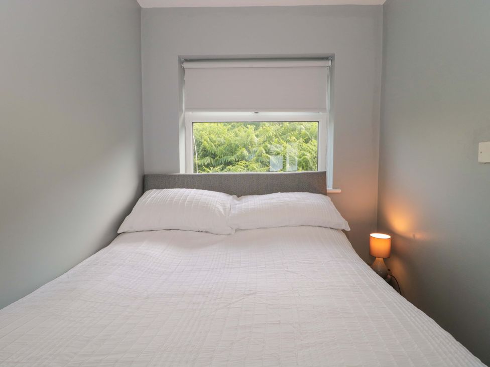 A bedroom with a bed and a window at Flat 24 in Brean