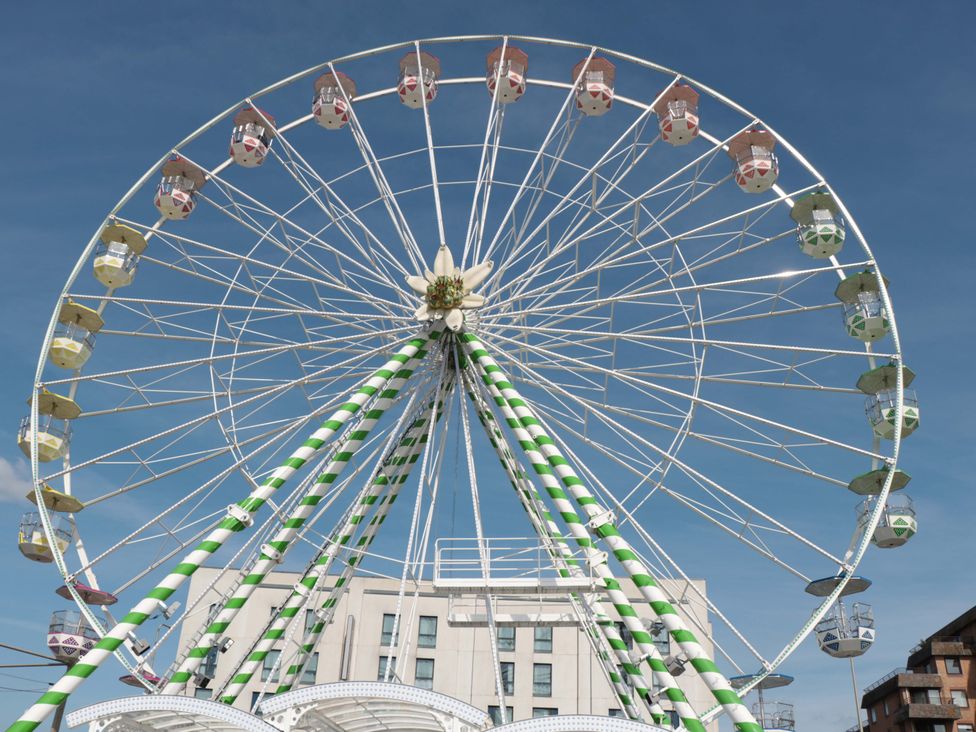 A ferris wheel with colorful buckets at Flat 24 in Brean