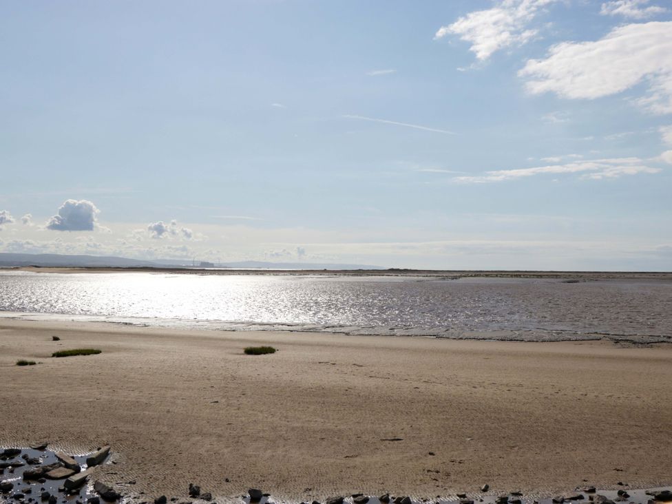 A landscape with sand and water under a clear sky at Flat 24 in Brean