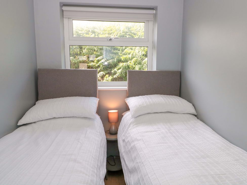 A bedroom with two beds and a window at Flat 24 in Brean