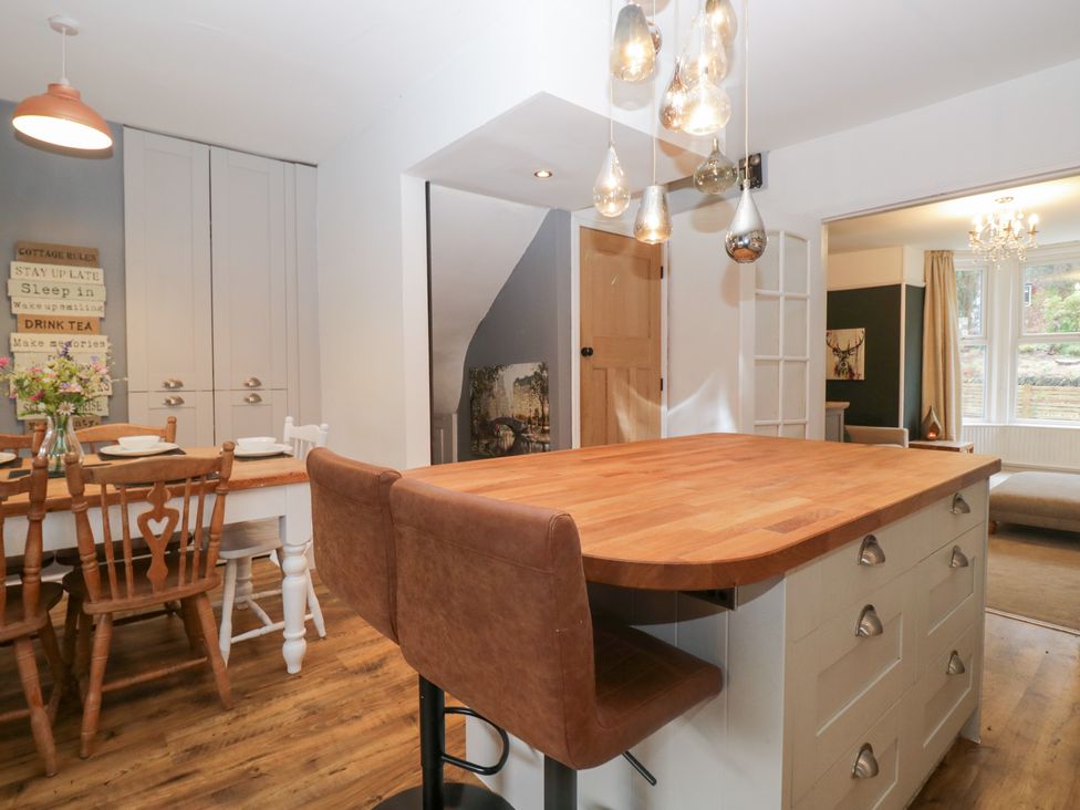 A kitchen with an island and dining table at The Wonky Nest in Bowness-On-Windermere