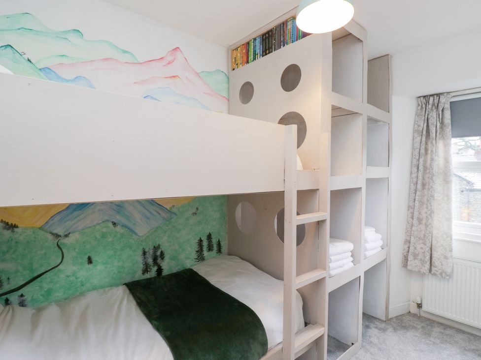 A bedroom with a bunk bed and shelving at The Wonky Nest in Bowness-On-Windermere