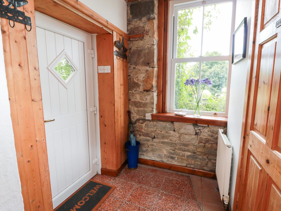 An entrance hallway with a front door and a window at Balsaggart Farm