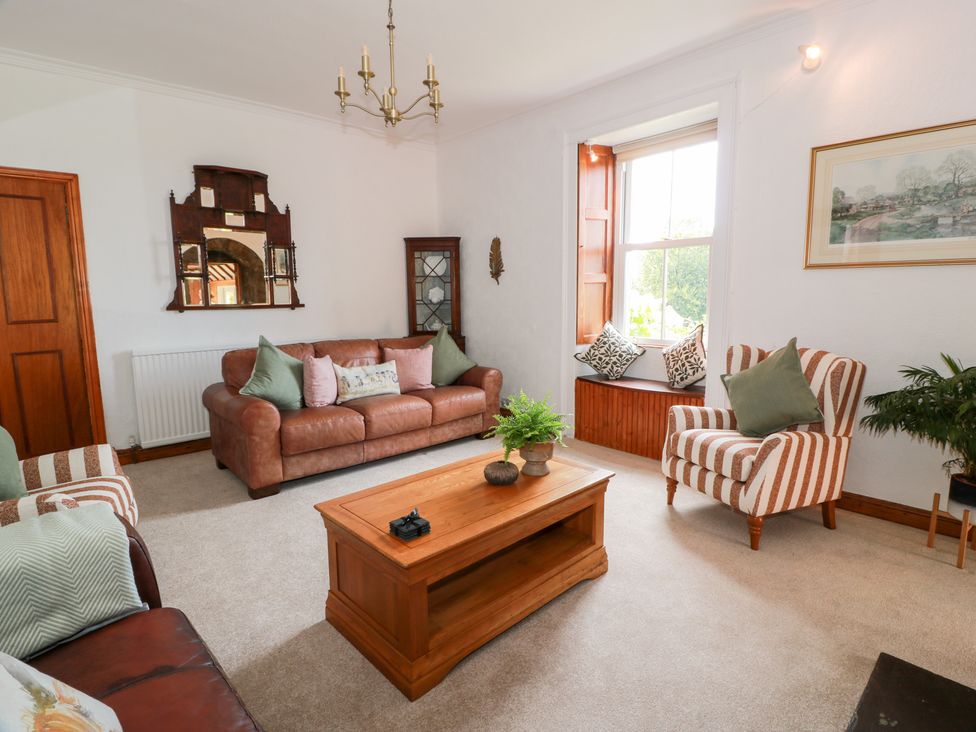 A living room with a sofa and coffee table at Balsaggart Farm 