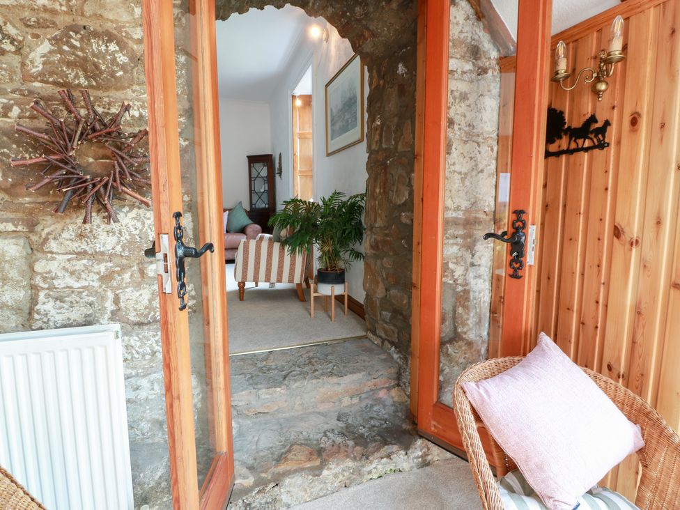 An entryway with stone wall and plants at Balsaggart Farm