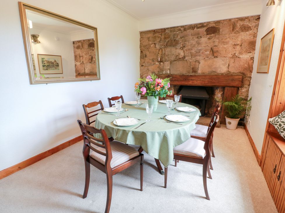 A dining room with a table and chairs at Balsaggart Farm