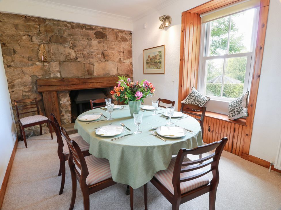 A dining room with a table set for dinner at Balsaggart Farm 